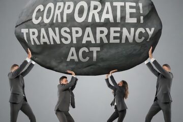 photo of team holding up rock; business law